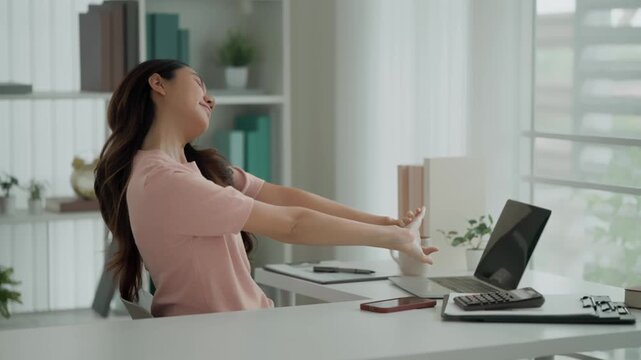 Asian woman takes a break from work. Relax and stretch