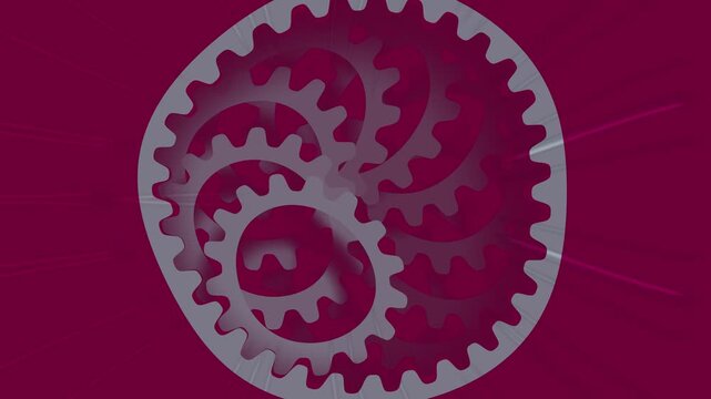 Rotating mechanical gears moving in a circular pattern against a deep purple background representing industrial mechanics and teamwork