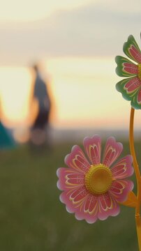 Wind-up toy, family fun background, bright green grass, orange sunset