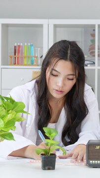 Teenage Girl in Lab Coat Recording Science Experiment Data