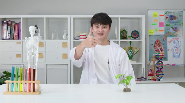 Smiling Teenage Student in Lab Coat Giving Thumbs Up in Science Classroom