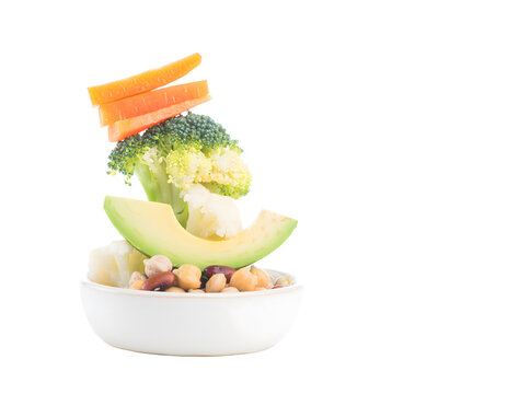 Fresh vegetable and legume salad bowl stacked with avocado broccoli cauliflower carrots and beans isolated on transparent background for healthy diet concept and nutrition design element