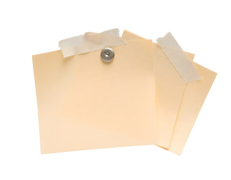 Stacked beige sticky notes pinned with a metallic pushpin and secured with masking tape isolated on a transparent background for creative office memo design projects and business reminders