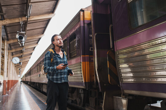 Traveler standing on train station platform waiting for departure