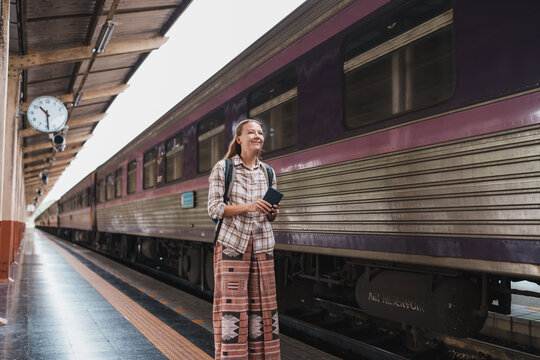 Woman passenger traveling by train at railway station