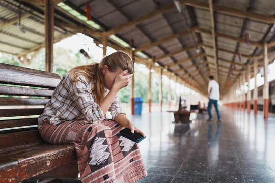 Woman feeling sad and disappointed at train station