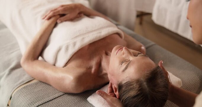 Neck, massage and mature woman at spa for holistic healing, wellness and deep tissue treatment. Hotel, resort and person with salon service for stress relief, circulation and pamper for self care