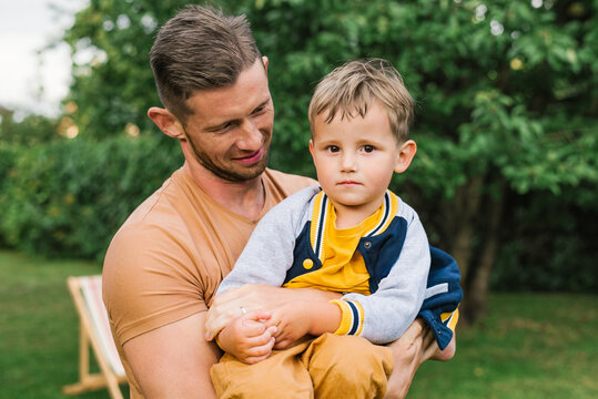 Father Looking At Son With Love In Park