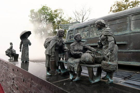 Kielce, Poland.  A sculpture by Sławomir Mick in front of the Kielce train station, featuring, among others, a Jelcz 43, commonly known as the "cucumber"