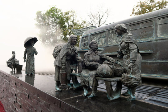 Kielce, Poland.  A sculpture by Sławomir Mick in front of the Kielce train station, featuring, among others, a Jelcz 43, commonly known as the "cucumber"