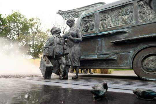 Kielce, Poland.  A sculpture by Sławomir Mick in front of the Kielce train station, featuring, among others, a Jelcz 43, commonly known as the "cucumber"