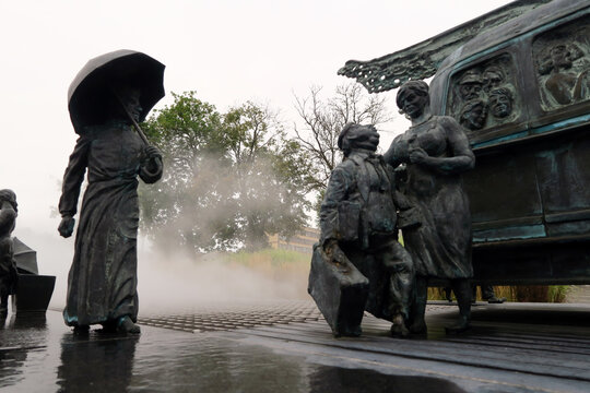 Kielce, Poland.  A sculpture by Sławomir Mick in front of the Kielce train station, featuring, among others, a Jelcz 43, commonly known as the "cucumber"