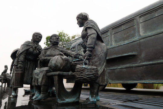 Kielce, Poland.  A sculpture by Sławomir Mick in front of the Kielce train station, featuring, among others, a Jelcz 43, commonly known as the "cucumber"