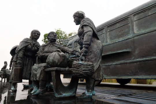Kielce, Poland.  A sculpture by Sławomir Mick in front of the Kielce train station, featuring, among others, a Jelcz 43, commonly known as the "cucumber"