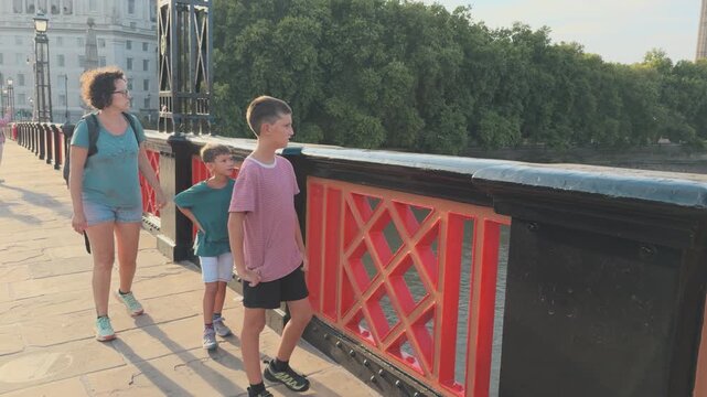 Mother and Sons Sightseeing on a Thames Bridge in Central London