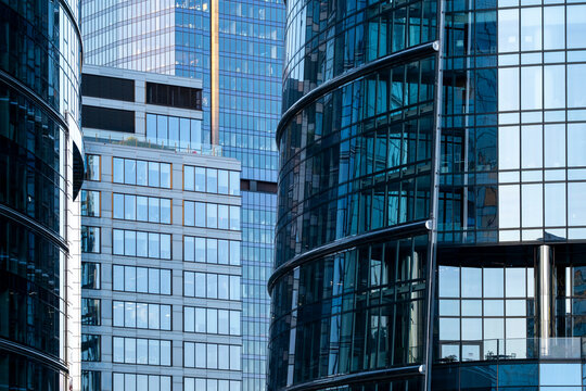 Contemporary office towers in Wola, Warsaw, Poland, showing curved glass facades and layered business architecture in the city financial district.