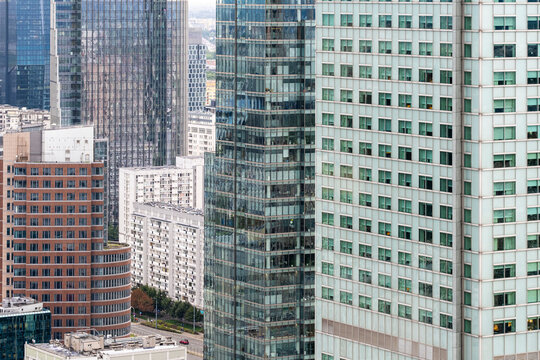 Dense group of office towers in the financial district of Wola, Warsaw, Poland, showing layered facades, windows and contemporary business architecture.