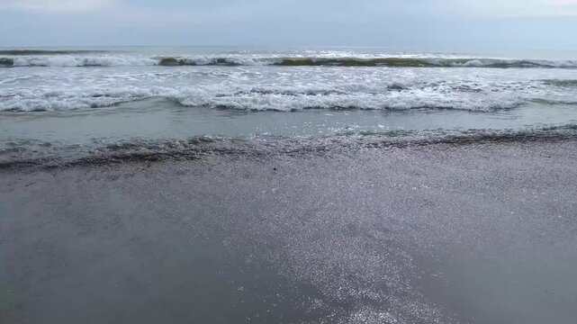 Beautiful coastal beach with rolling sea waves video footage
