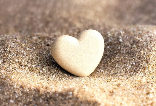 Small heartshaped object delicately placed on fine sand background showing simplicity and love concept