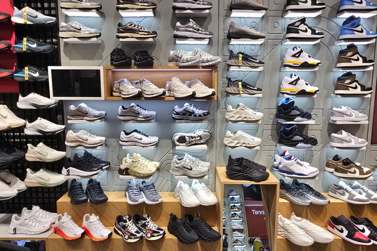 Penang, Malaysia - Sep 06, 2026: Modern footwear display wall in a Nike retail store featuring rows of athletic sneakers, running shoes, and lifestyle footwear inside a shopping mall.