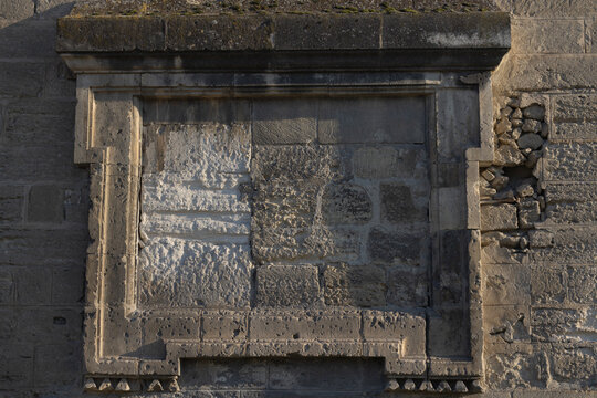 Avignon, France -  A weathered stone plaque embedded in the medieval ramparts of Avignon, likely a historical monument plaque.