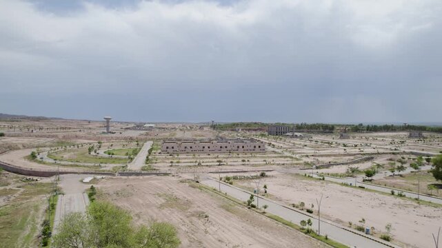 Cleared land, paved roads and planted areas form the early stages of a large urban development