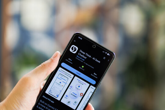Hand holds phone displaying app store screen for Deep Think AI Seek Chatbot