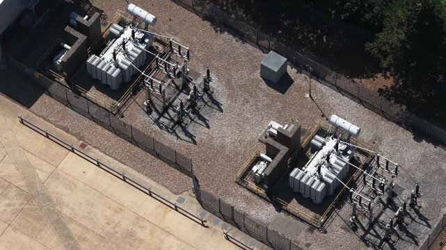 Electrical power substation aerial view with transformers and grid
