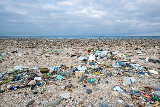 Ocean Pollution: A Beach Covered in Plastic Waste. A sad view of a beach heavily polluted with plastic waste, highlighting the environmental crisis
