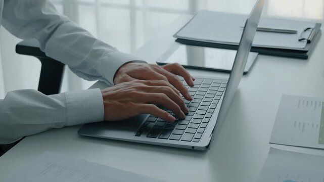Close up of businessman using laptop working with digital data