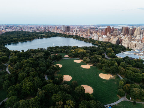 Aerial view of Central Park surrounded by Manhattan skyscrapers and New York City skyline.
