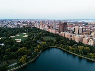 Fototapeta premium Aerial view of Central Park surrounded by Manhattan skyscrapers and New York City skyline.