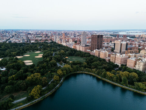 Aerial view of Central Park surrounded by Manhattan skyscrapers and New York City skyline.
