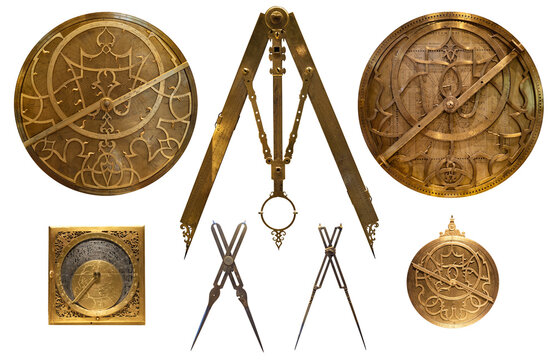 Collection of antique historical astronomical instruments astrolabes and antique drawing compasses, dividers, sector, calipers, drafting tools isolated on white background. 