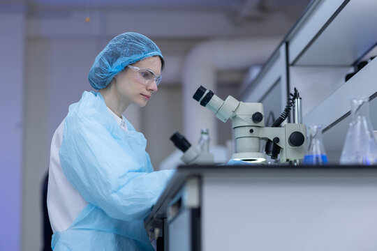 Women scientist working with microscope in laboratory for scientific research, sample analysis, biotechnology, microbiology, medical testing, precision examination, laboratory technology.