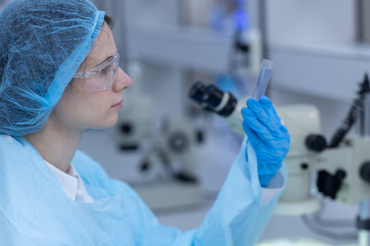 Women scientist examining test tube sample in laboratory for scientific research, biotechnology, microbiology, medical testing, quality analysis, precision inspection, laboratory technology.