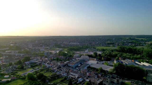 September 02, 2026 - Cinematic pullback drone shot over the town of Halle in Belgium during a beautiful golden hour sunset.