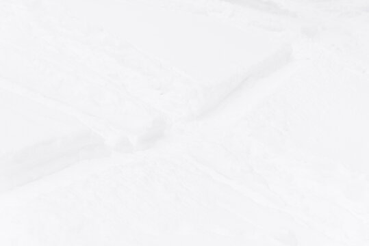 Snow covered landscape with winding footpaths and trails, fresh white winter snow texture, minimalist natural background, peaceful cold season scene, outdoor travel and seasonal concept