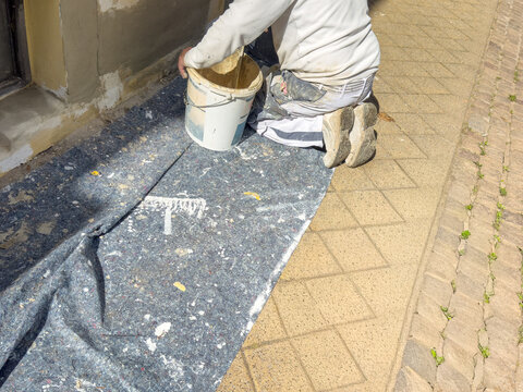 worker painting a concrete wall