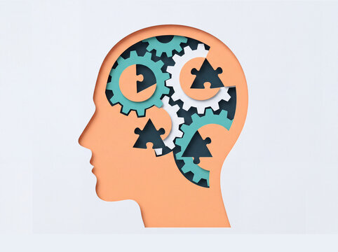 Papercut profile of human head with internal gears and puzzle pieces representing mental process and logic