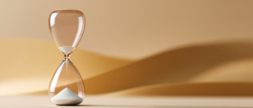 A sand timer with a beige background and blurred lines in the distance, conveying time passing or running out
