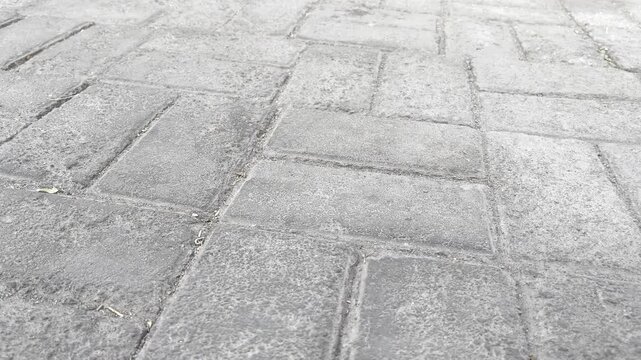 High angle view of dark gray concrete paving stone texture