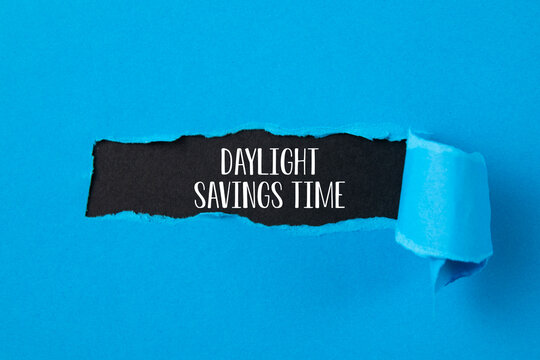 Daylight Saving Time on torn ripped  paper 
