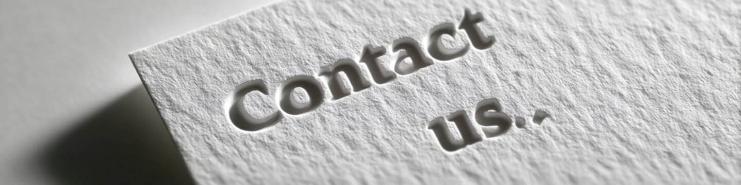 A close up of a business card with embossed text that says Contact us. on it, suggesting the recipient should reach out to learn more about their services or products