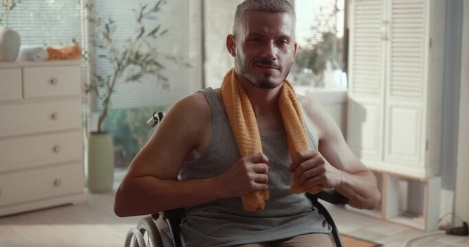 Portrait of a young man in a wheelchair in the bathroom after completing his morning personal hygiene routine at home.