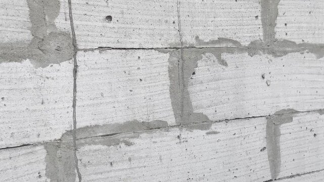 Raw construction site detail of wet plaster on block wall