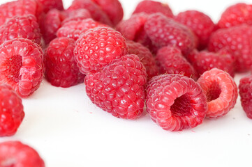 Fresh raspberries on a white background. Selective focus. Raspberries isolated on a white background, close-up. © Alina Yermakova
