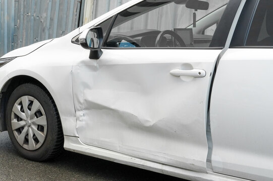 Close-up of a white car body. Car after an accident.