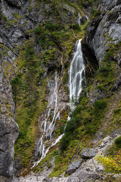 Scenic vertical waterfall in Silberkarklamm gorge in Austria with mossy rocks and flowing water