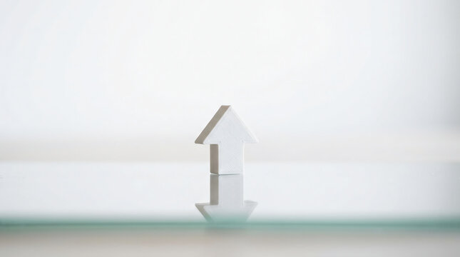 White 3D Upward Arrow Symbol Representing Business Growth Financial Success and Progress Standing on Reflective Glass Surface in Minimalist Bright Clean High Key Studio Photography